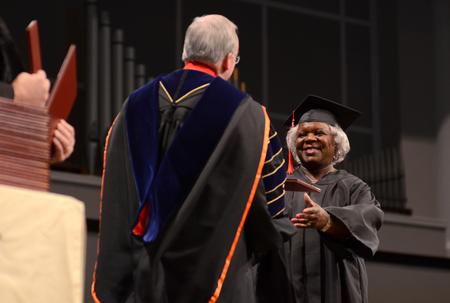 Roxie Jackson, associate of divinity, accepts her diploma from David S. Dockery, president of the university, during Fall Commencement. - Photo by Jacob Moore