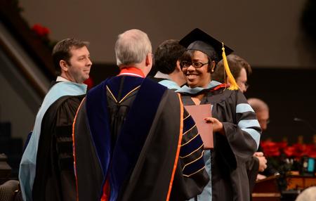 Jacqueline Taylor, doctor of education, receives her diploma from David S. Dockery, president of the university, during Fall Commencement. - Photo by Jacob Moore