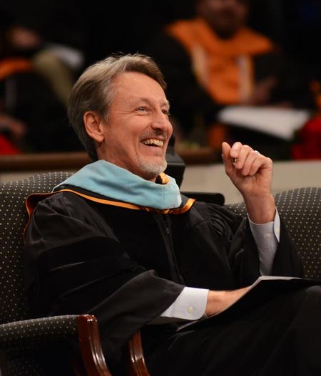 Claude Pressnell, president of the Tennessee Independent Colleges and Universities Association, laughs as David S. Dockery, president of the university, wishes him a happy birthday during Fall Commencement. - Photo by Zac Calvert