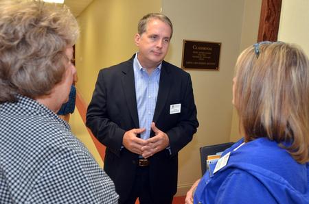 Jim Avery, associate vice president for information technology, talks to faculty members before giving a presentation at the beginning of the Fall semester.  - Photo by Morris Abernathy