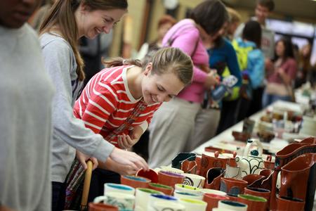Students and community members shop the annual Christmas pottery sale. Most of the artwork displayed is made by students, with a few tables of faculty and staff work as well. - Photo by Kristi McMurry Woody