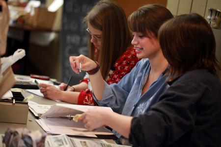Members of the Potter's Guild take up money at the annual Christmas pottery sale in the SUB hallway.  - Photo by Kristi McMurry Woody