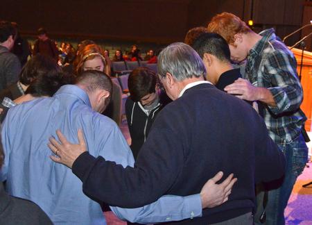 David S. Dockery, president of the university, prays with students and alumni involved in the Fifth Year Remembrance chapel before the beginning of the service.  - Photo by Morris Abernathy