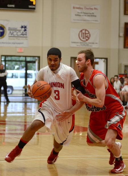 Freshman Bulldog Roy Bullock drives against Christian Brothers' Dominic Fragale during a home game. - Photo by Jacob Moore