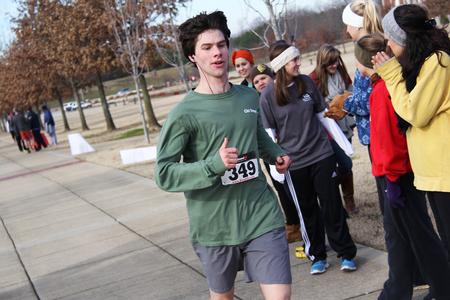 Alex Wainscott, junior Engineering major, crosses the finish line at the Chi Omega 5k during Homecoming weekend. - Photo by Matt McDaniel