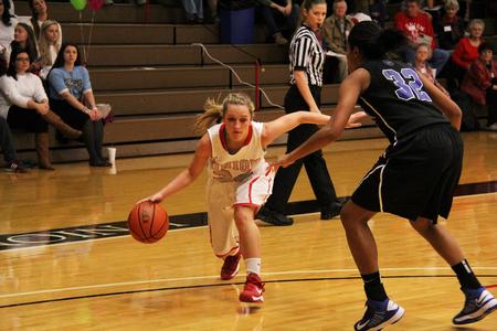 Amy Philamlee dribbles past a Lady Hawks defender for a lay up.  - Photo by Matt McDaniel