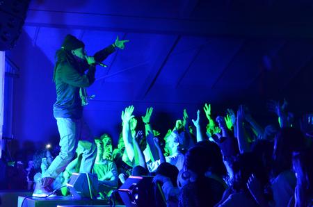The crowd sings along as hip hop artist Dee-1 performs during the Homecoming concert. - Photo by Anne Richoux