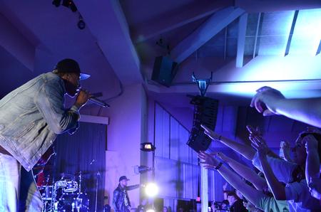 The audience excitedly reaches toward LeCrae as he performs at the Homecoming concert.  - Photo by Anne Richoux