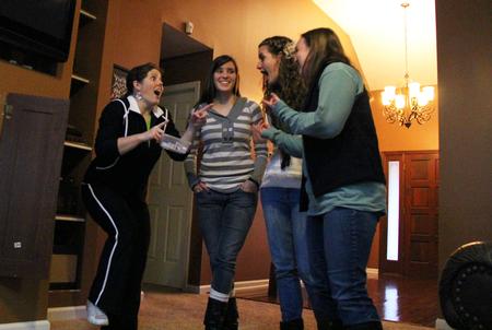 Emily Lean, assistant professor of management, Megan Kersey, sophomore art major, Ruth Bone, sophomore nursing major, and Kristen Miller, junior business administration major, team up for a game of charades during Be Our Guest. - Photo by Matt McDaniel