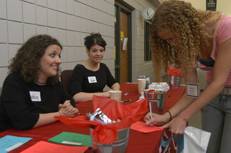 Juniors Ashley Mitchell and Jodie Curtis help incoming freshmen sign in during The Spring Thing Weekend. - Photo by Jonathan Blair