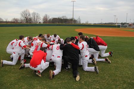 Union University Bulldogs say the Lord's Prayer together before the game against the Freed-Hardeman Lions. - Photo by Matt McDaniel