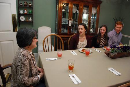 Alice Nettles, wife of physics department chair Bill Nettles, talks with students Rebecca Blevins, Samantha Adams, and Ryan Linkous. Bill and Alice Nettles welcomed students into their home for dinner as a part of SAC's Be Our Guest. - Photo by Anne Richoux