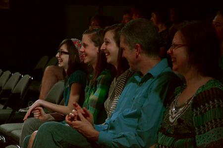 Guests laugh as guest artist Doug Berky performs in the W.D. Powell Theatre.  - Photo by Anne Richoux