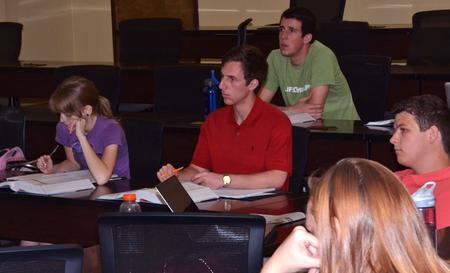 Business students listen to a lecture and participate in discussion during class. - Photo by Olivia Wallace