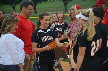 Keaton Kirk, senior athletic training major, accepts flowers and a framed jersey during the recognition of seniors before the game. - Photo by Matt McDaniel