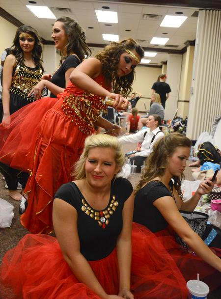 Members of Chi Omega add glitter spray to their hair before the 16th annual Variety Show. - Photo by Jacob Moore
