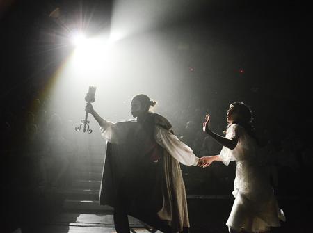 The Phantom, played by Claudia Velasco, leads Christine, played by Tori Brooks, across the stage to the opera house's underground lair during Zeta Tau Alpha's performance of "Phantom of the Opera" at the 16th annual Variety Show. - Photo by Jacob Moore