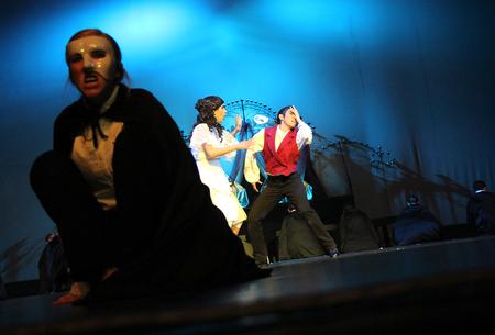 Tori Brooks, junior english creative writing major, plays Christine and rips of the mask of the phantom played by Claudia Velasco, senior philosophy major during the 16th annual Variety Show at the Carl Perkins Civic Center. - Photo by Matt McDaniel
