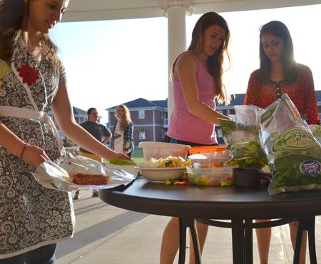 Students create three recipes which include southwestern black bean salad, meat and vegetable grill packets, and delicious homemade brownies during Cooking with Class, a residence life event.  - Photo by Olivia Wallace
