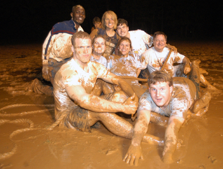 The winning team in the Young Alum's Midnight Mudness event included Trae Cadenhead, Nathan Hooper, Kolo Goshi, Ruth Schroeder, Paul Travis, Kristin Ulmer, and Kate Mosley. Also pictured is Young Alums staff advisor Gary Williams, associate vice president for advancement and executive director of for alumni services. - Photo by Jonathan Blair
