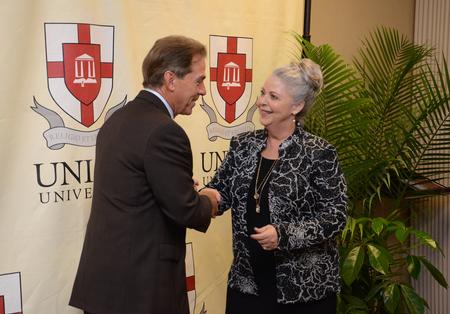 Nick Saban, head football coach at the University of Alabama, greets Deb Rhodes, office coordinator of university communications, at the fifth annual Roy L. White Legacy Golf and Gala. - Photo by Jacob Moore