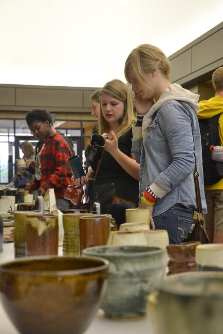 Students enjoy picking out pieces of pottery made by their peers at the annual Mother's Day pottery sale.  - Photo by Olivia Wallace