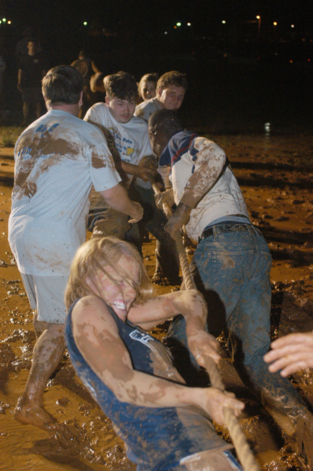 Juniors tug hard during the mud tug-of-war during the Young Alum's Midnight Mudness. - Photo by Jonathan Blair