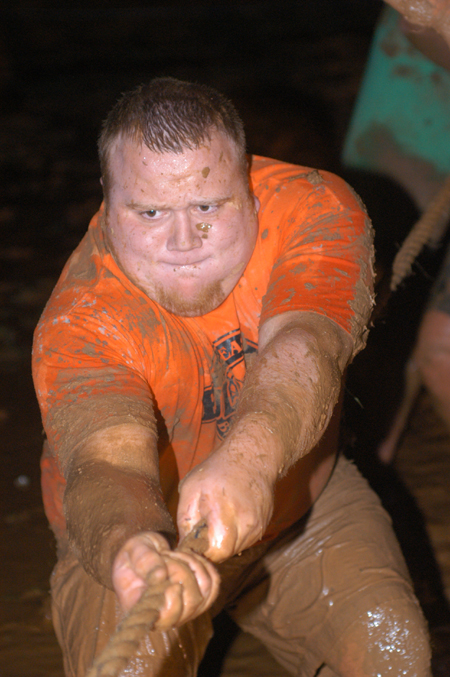 Junior Matt Oshel uses his brawn during the Young Alum's Midnight Mudness. - Photo by Jonathan Blair