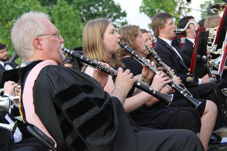 David McClune, university professor of music, plays with the Symphonic Band at the start of Spring Graduation. - Photo by Matt McDaniel