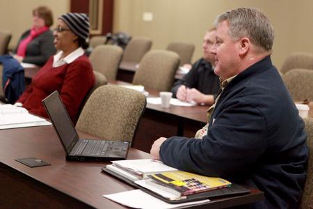MBA students listen and take notes during class at the Center for Continuing and Professional Studies. - Photo by Kristi McMurry Woody