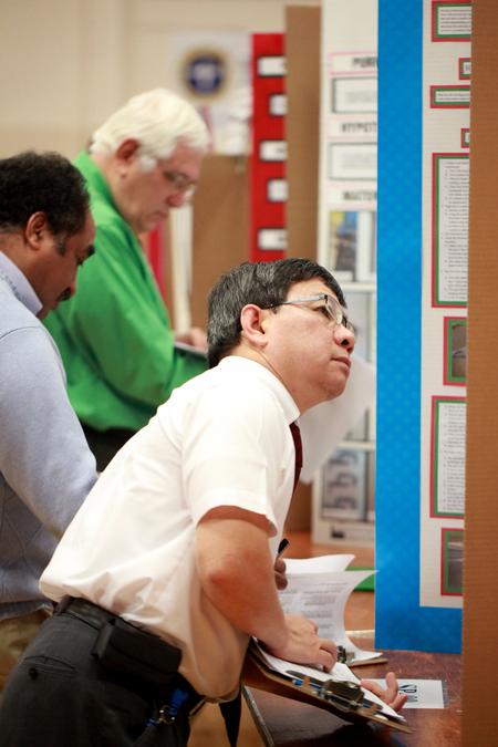 Don Van, professor of engineering, judges the science projects of area students during the Science Fair hosted by Union. - Photo by Kristi McMurry Woody