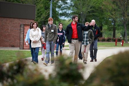 A student ambassador gives a group of prospective students and their families a tour of campus during Preview Day.  - Photo by Kristi McMurry Woody