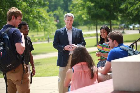 David Thomas, professor of history, chats with some students between classes.  - Photo by Kristi McMurry Woody