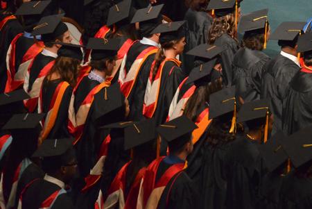 Graduates stand for prayer during summer commencement services at West Jackson Baptist Church.  - Photo by Morris Abernathy