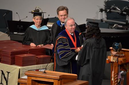 David S. Dockery, president of the university, congratulates graduates as they receive their diplomas at the summer commencement services.  - Photo by Morris Abernathy