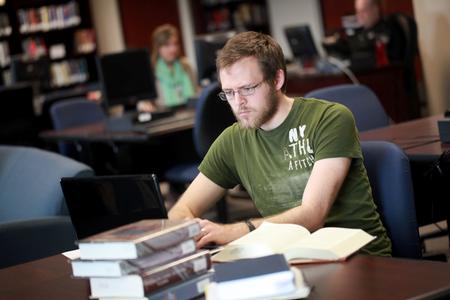 Zach Thompson, graduate student, works on a paper in the R.C. Ryan Center for Biblical Studies. - Photo by Kristi McMurry Woody