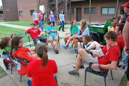 Upperclassmen students take a break in the Heritage Complex after helping new students move in to their residence complexes. - Photo by Anne Richoux