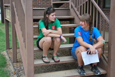 Life Group leader Megan Kersey and resident advisor Megan Peden chat after helping with new student move-in day. - Photo by Anne Richoux