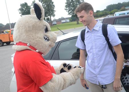Jack Saylor, freshman Biblical studies major, meets Buster the Bulldog before moving into his room on new student move-in day. - Photo by Matt McDaniel