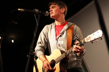 Quinten Brasher, freshman history major, performs for fellow new students during open mic night at Barefoots Joe. - Photo by Matt McDaniel