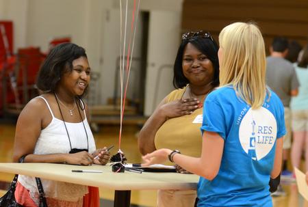 New student Jasmine Hailey, freshman biology major, chats with her mother Cathy and resident advisor Linnea Verhagen, sophomore nursing major, during new student move-in day. - Photo by Jacob Moore