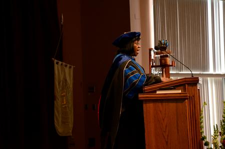 Rhonda Hudson, professor of social work and acting program director for the bachelor of social work program, leads in the reading of the Apostles Creed during Fall Convocation. - Photo by Anne Richoux
