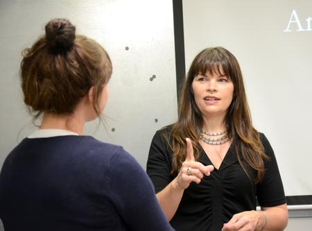 Angela D. Lee, visiting artist, talks with Kathryn Buncik, senior art major, after giving a lecture about her show "Stories Beneath the Water" in the Union art gallery. - Photo by Amanda Rohde