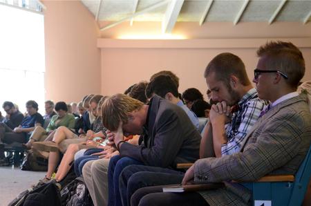 Student bow their heads in prayer during chapel. - Photo by Anne Richoux