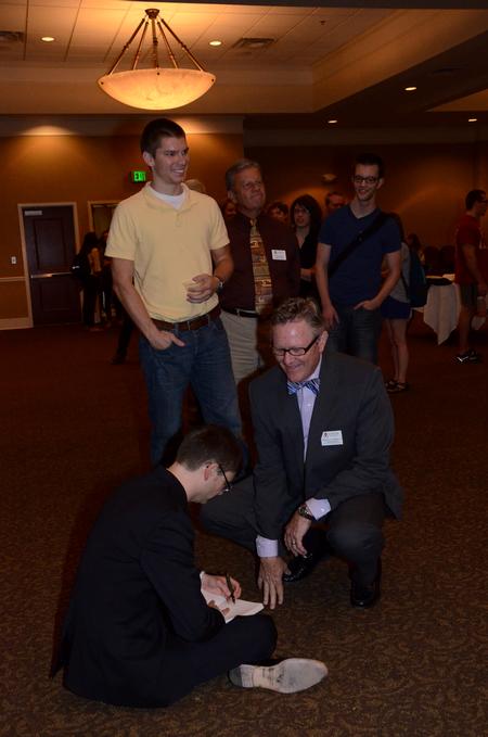 Greg Thornbury, president of The King's College in New York, autographs his book "Recovering Classic Evangelicalism: Applying the Wisdom and Vision of Carl F.H. Henry" for Greg Jordan, professor of business law and ethics, during a reception in honor of the Thornburys' return to campus. 
 - Photo by Anne Richoux