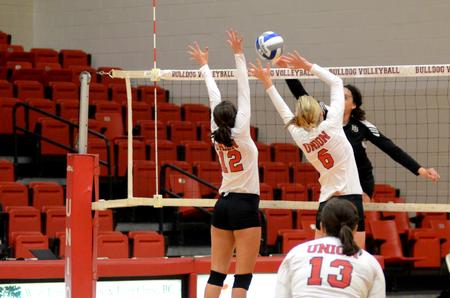 Lady Bulldogs Abbey Wainwright and Mallory Baker go up for a block against Harding University. - Photo by Anne Richoux