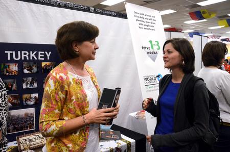 Kathy Reed, former IMB missionary, talks with Ryan Edenfield, senior Biblical languages major, at the GO Week Expo in Brewer Dining Hall. - Photo by Anne Richoux