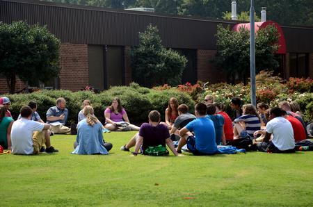 Ken Litscher, director of residence life, talks with students while having class outside during a beautiful day on Union's campus.  - Photo by Anne Richoux