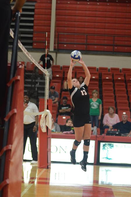 Lady Bulldog Lydia Wright sets the ball in a match against the University of Arkansas at Monticello. - Photo by Amanda Rohde