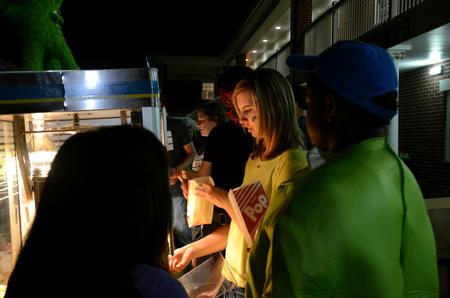 Student Activities Council members serve snacks to students and their families at Movie on the Lawn during Family Weekend. - Photo by Amanda Rohde